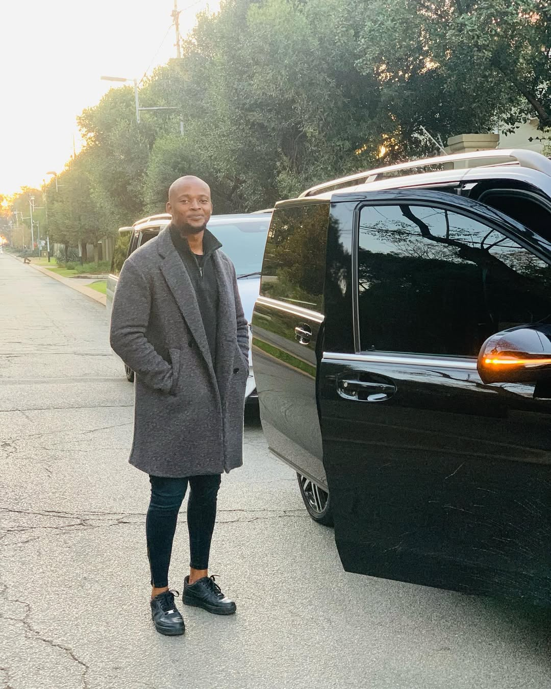 Client beside a black V-Class on a city street