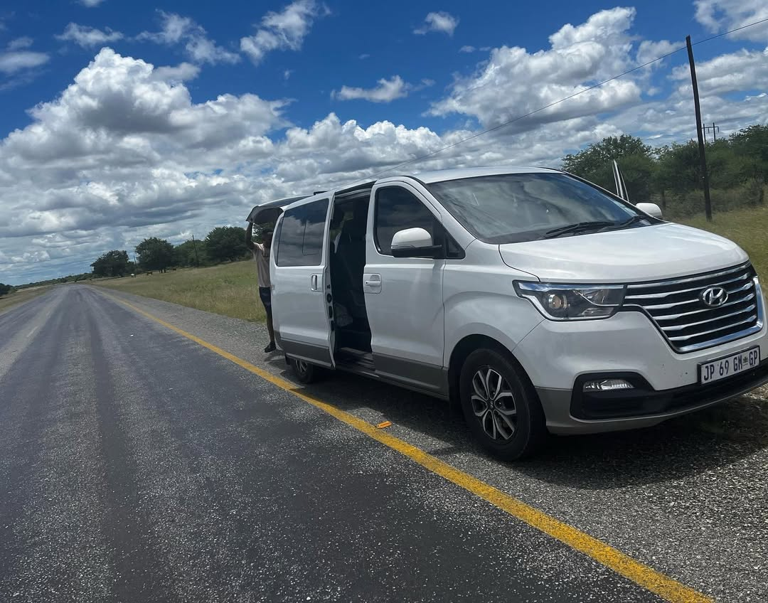 White shuttle van on a long-distance road transfer
